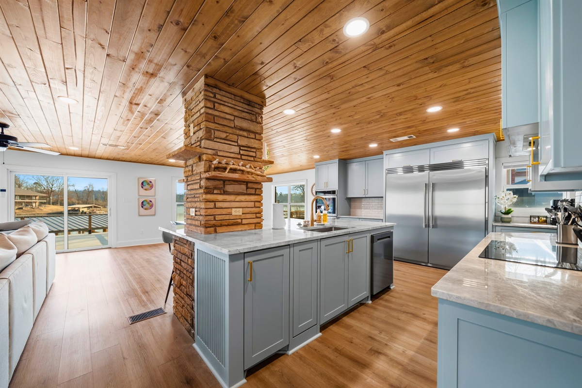 Clean lines, modern appliances, and plenty of counter space make this kitchen both stylish and practical for preparing meals for a group.