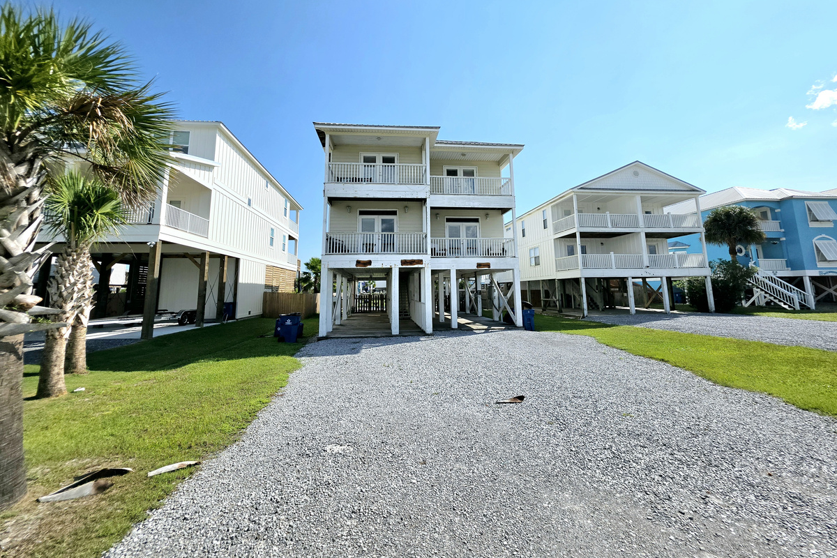 Turtles Nest Unit A – elevated home on West Lagoon Ave with gravel driveway