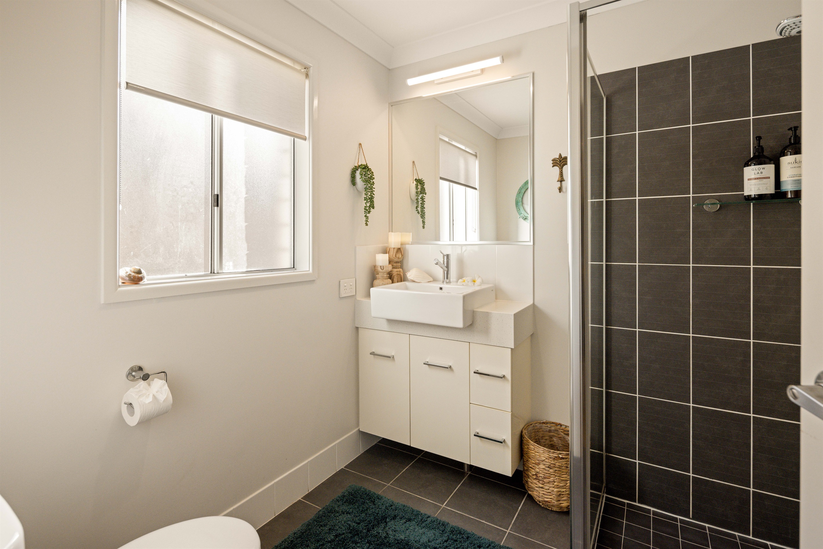 Private ensuite with shower, vanity, and toilet.