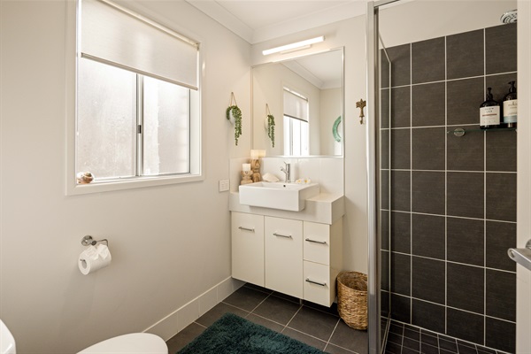 Private ensuite with shower, vanity, and toilet.