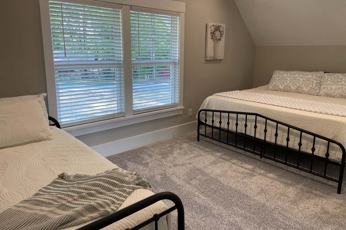 Upstairs street-side, bedroom #2, has a king and twin day bed