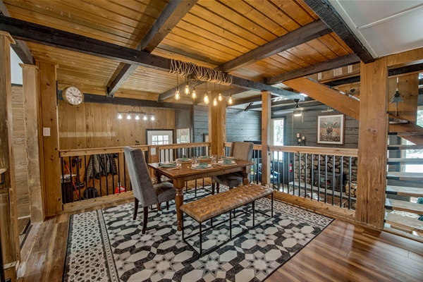 Gather around your rustic dining space—warm wood beams, cozy lighting, and a table set for you and yours to share meals and memories.