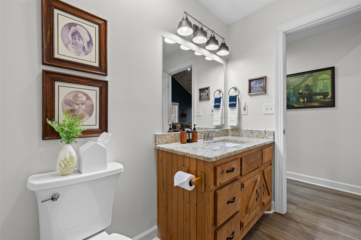 Half bathroom located off hallway near back living room.