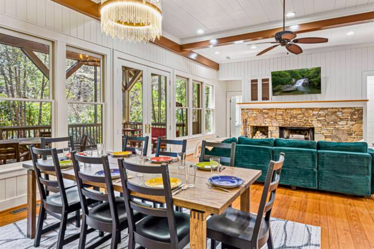 Open Concept Between the Living Room and Dining Area with Accented Exposed Beams