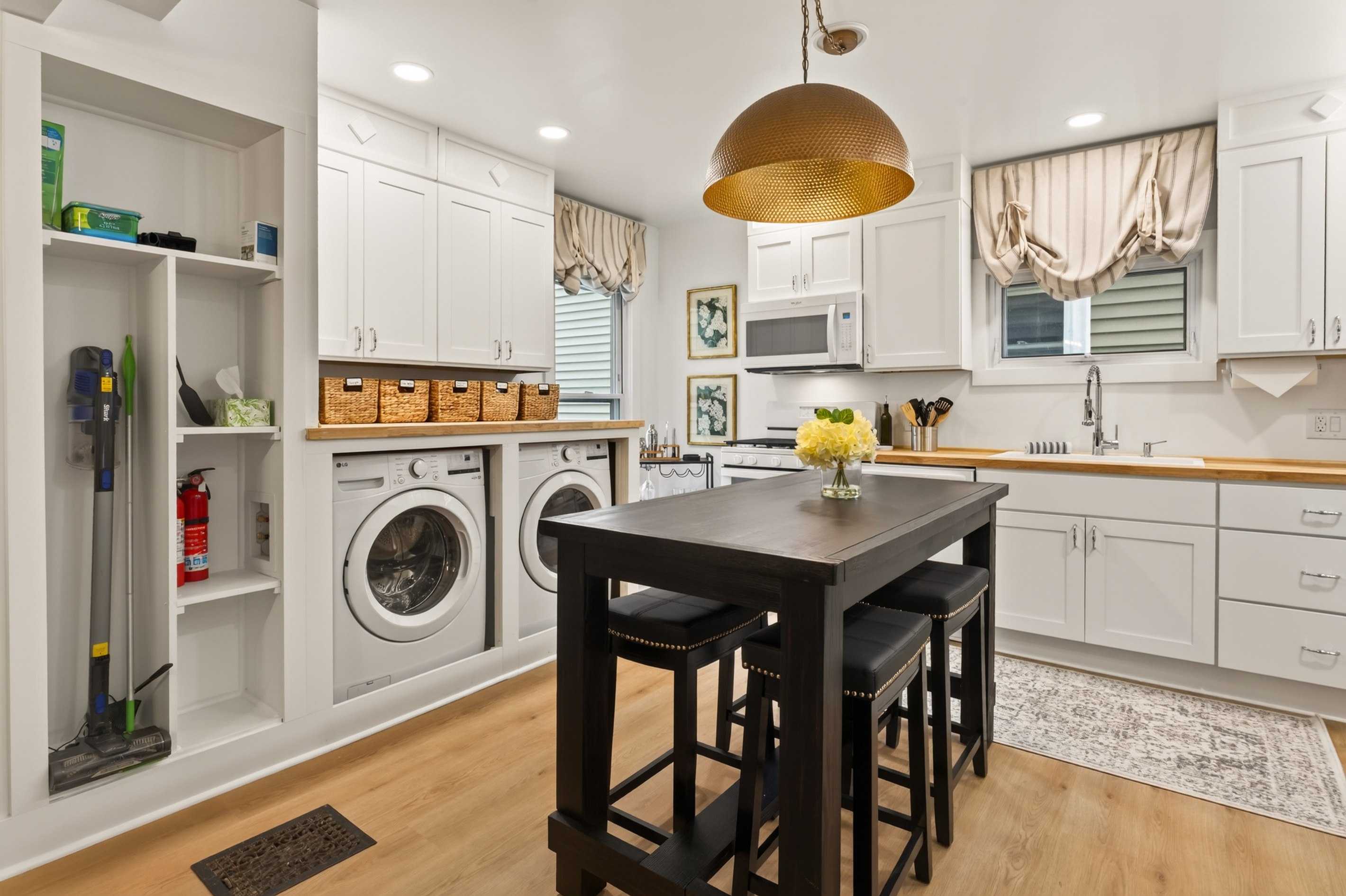 Kitchen with laundry area in the background