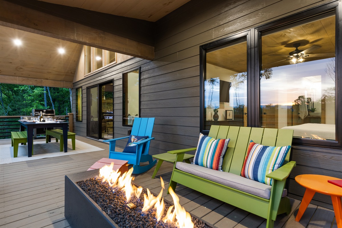 Gather around the glowing fire table, dine al fresco, and savor the mountain views from this vibrant outdoor space.