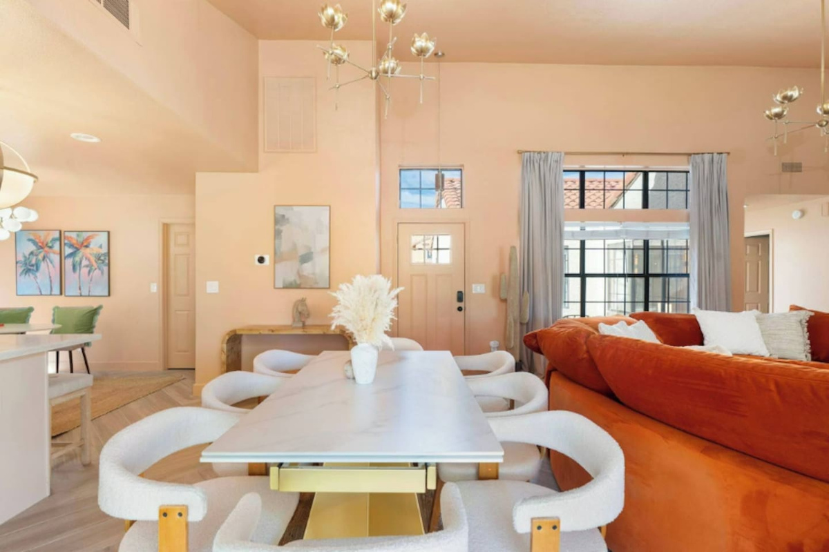 Open dining and living space with soaring ceilings, abundant natural light, and thoughtful finishes—designed for gatherings and connection.