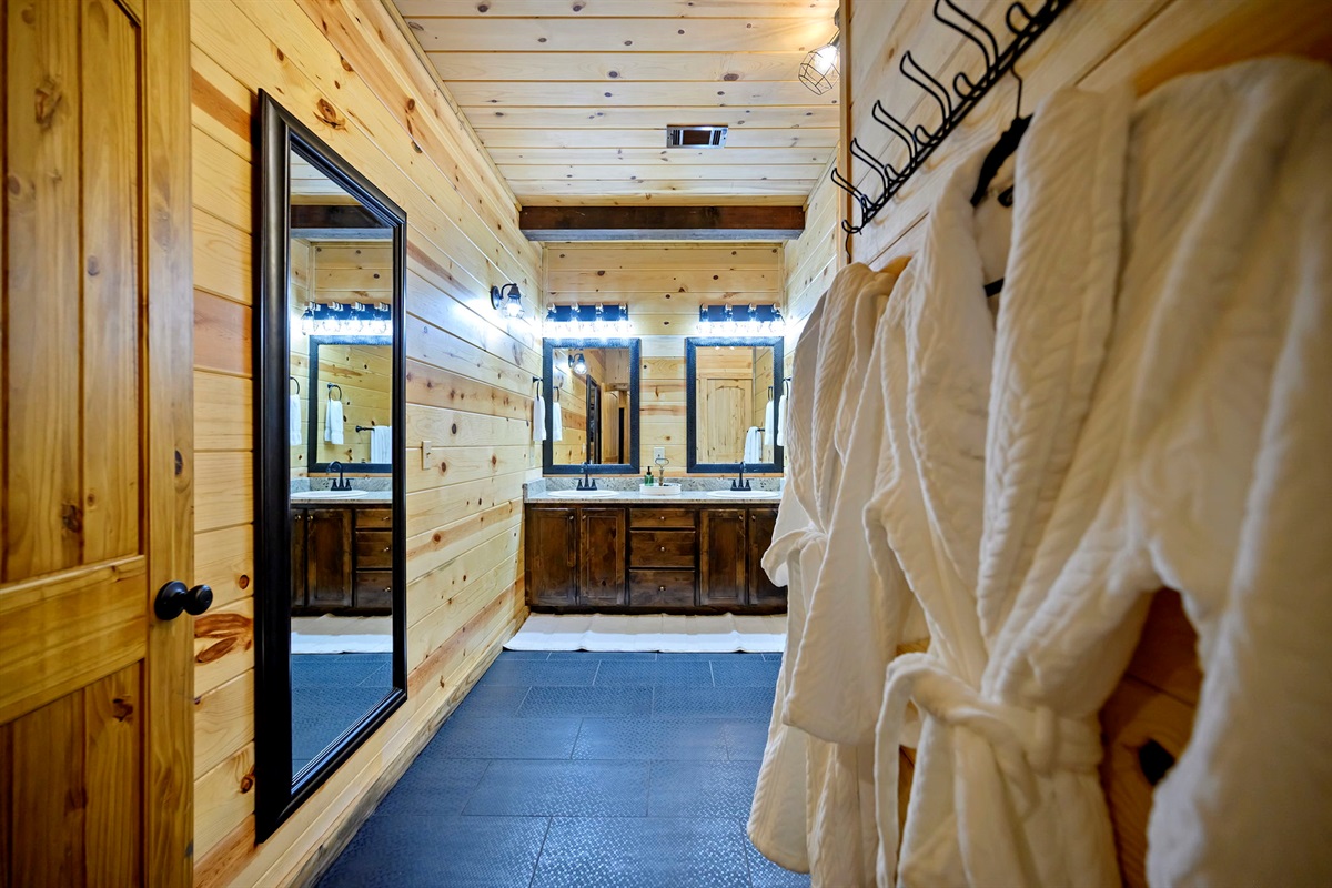 Private dressing area with robes and dual vanities for a spa-like start to your day