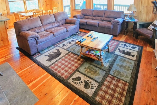 Comfortable living room after a full day. Coffee table has been updated to an ottoman. One of the sofas has a pull-out beds. Another sofa bed is downstairs.
