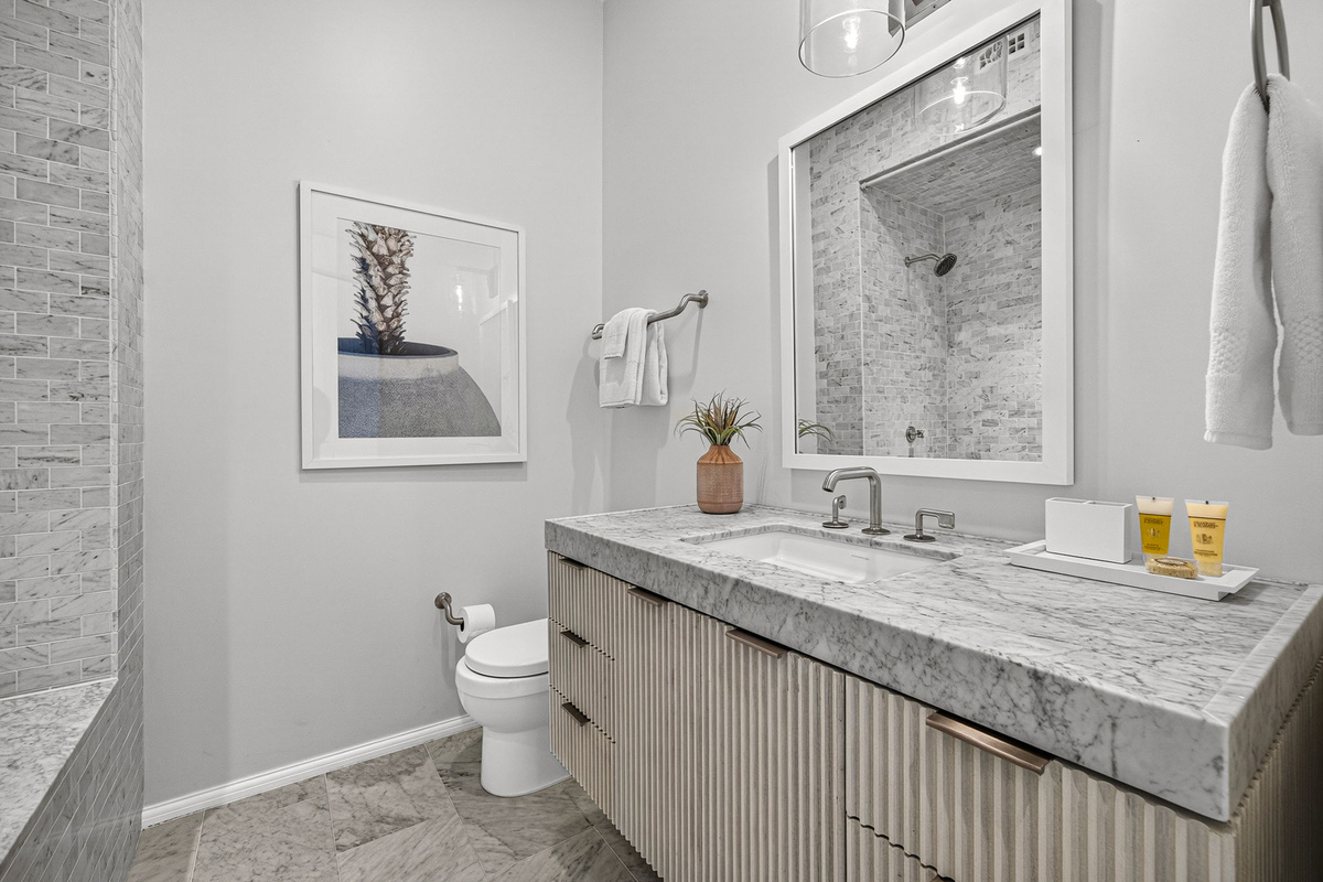 Guest Suite #1 offers an oversized vanity and deep soaking tub with shower.