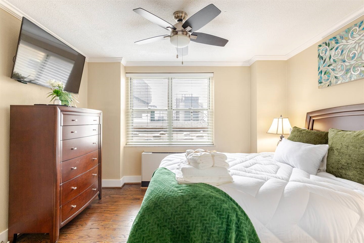 Comfortable guest room w/ large window & cozy bedding.