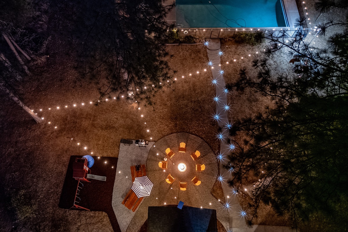 Unwind in this perfect backyard oasis: cozy up by the fire pit with friends, enjoy a meal at the picnic table or cook up a feast on the BBQ grill and pizza oven. Watch the kids play on the structure, relax under the string lights, and take a dip in the spa