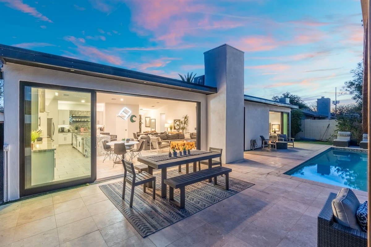 Golden hour paints the patio with soft color as you unwind by the pool—an ideal backdrop for evening conversations and drinks.