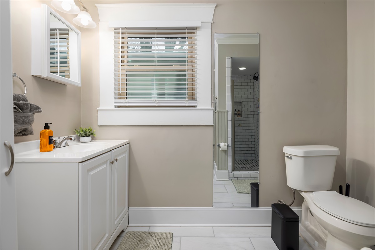Refresh and prepare for your day in our well-appointed bathroom, complete with a full-length mirror to ensure you look your best, harmonizing convenience with a touch of elegance. Message us a