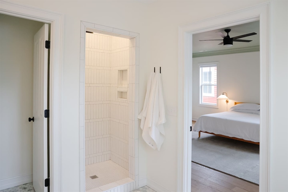 The primary bathroom features dual vanities, a private toilet area, a stand up shower and a soaking tub.