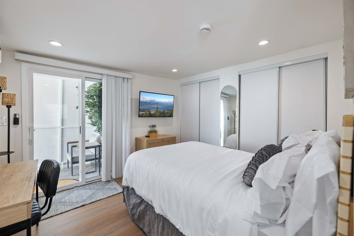 Bedroom 3 - Full bed and workspace. Flat screen smart TV and large closet. Slider door to outdoor patio.