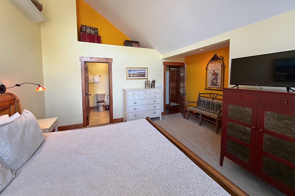 Large primary bedroom with King bed, attached full bathroom and private balcony.
