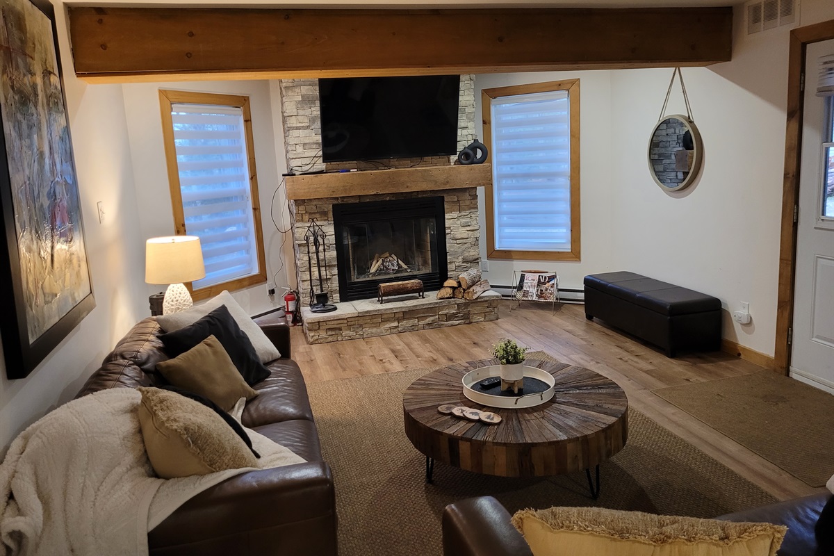 Wood-burning fireplace and seating area; firewood is provided