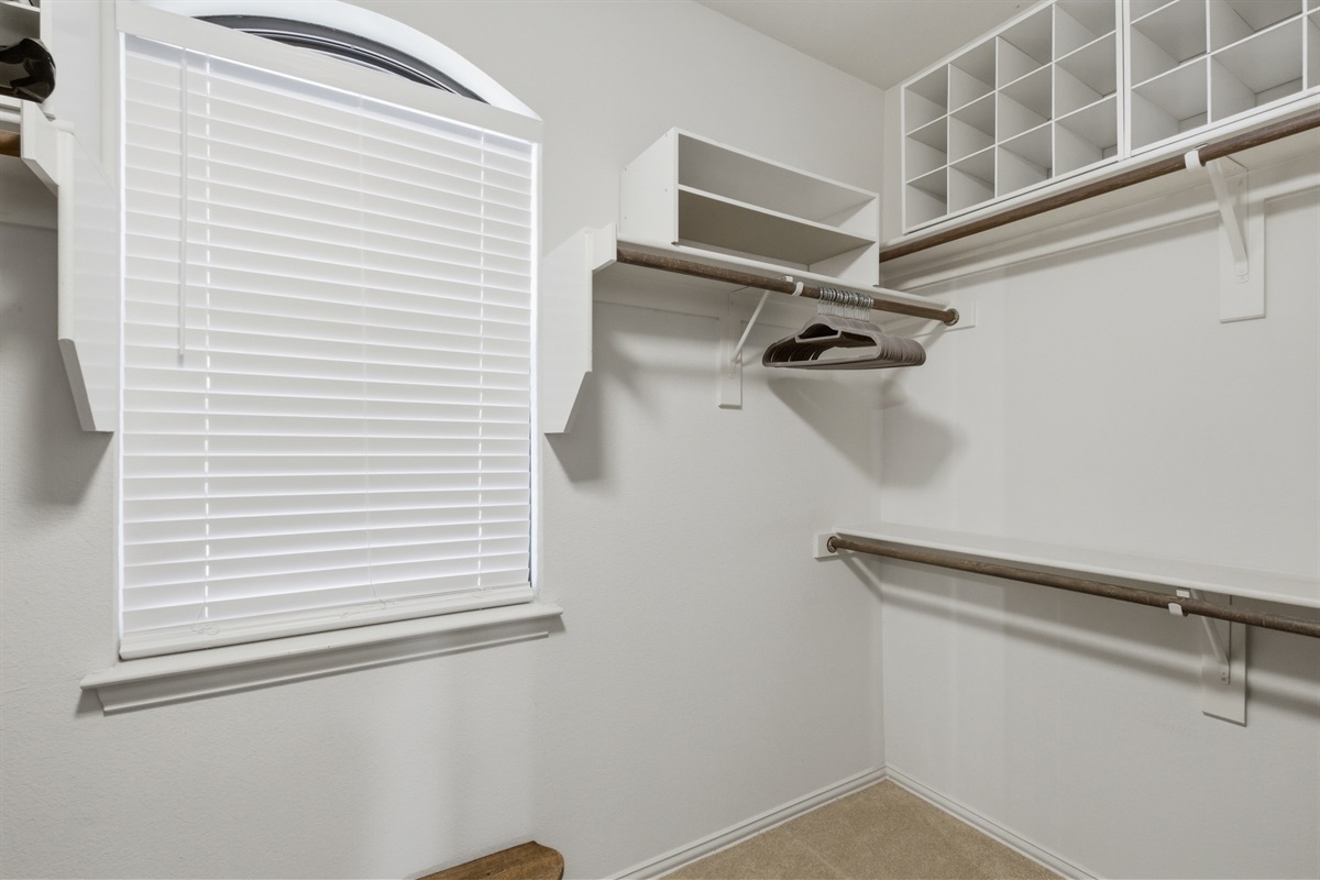 Walk-in Master Closet with hanging space, shelving, and storage. The Pack n Play is stored inside for traveling families.
