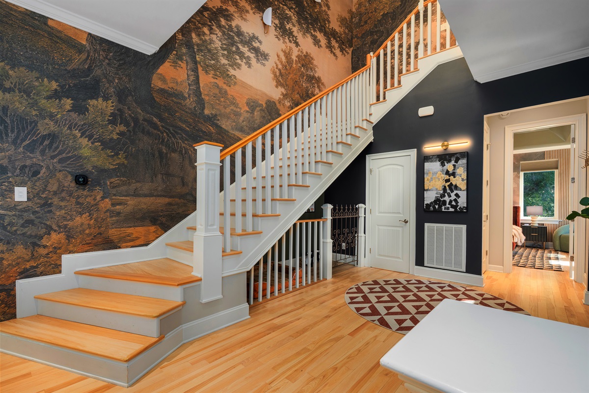 Grand entry with staircase and custom wall design - sets the tone for a clean, design-forward interior