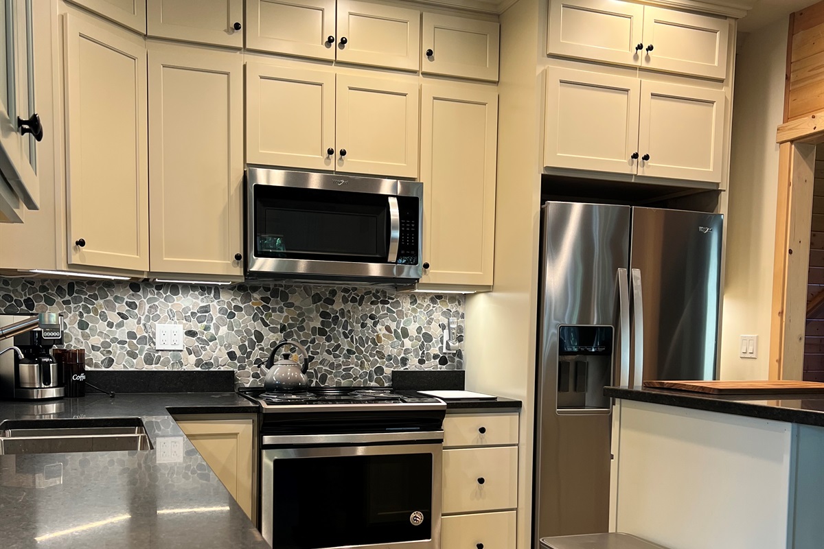 Warm and welcoming kitchen as part of great room allows everyone to gather together and visit in one large, open space.