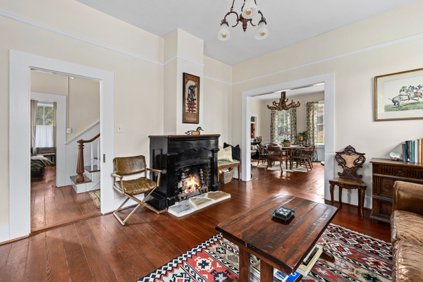 An easy-start gas fireplace brings instant warmth to the living room, framed by a dramatic black mantel and vintage andirons. Pull up a chair, pour the wine and let the conversation run deliciously long.