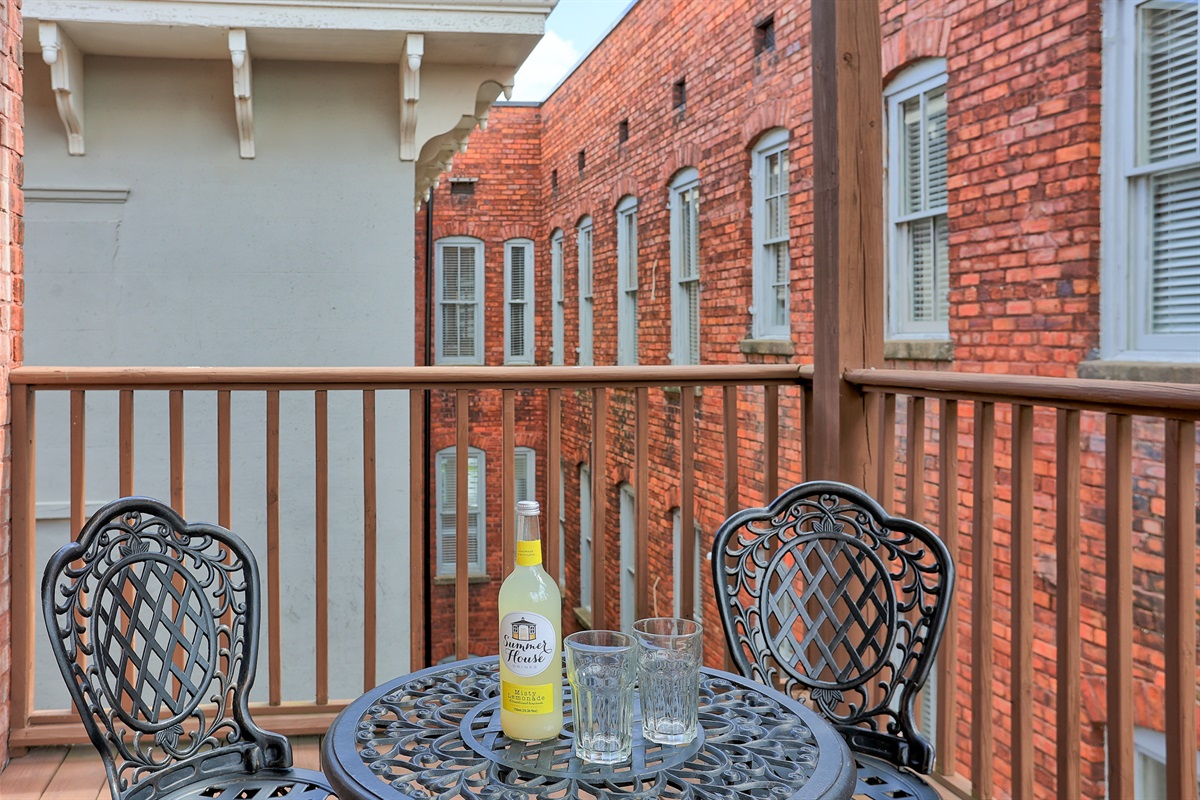 Relax outdoors rain or shine in this cozy, covered porch space.