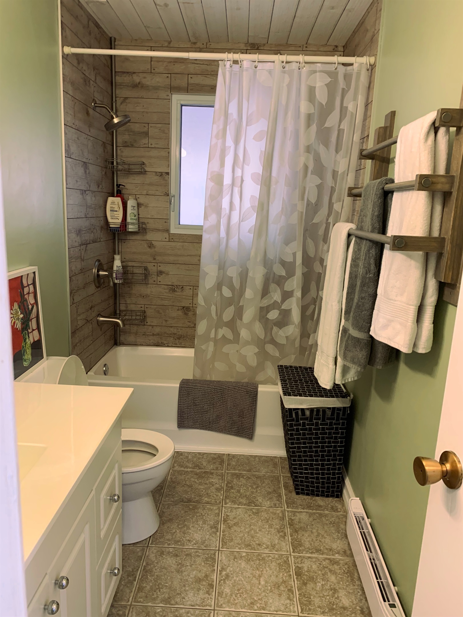Three-piece full bathroom showing tub & shower, counter etc.