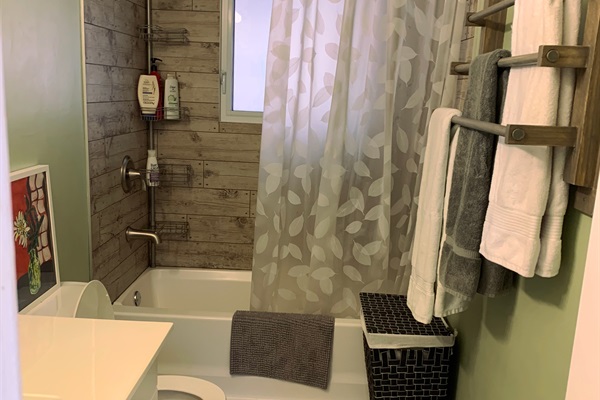 Three-piece full bathroom showing tub & shower, counter etc.