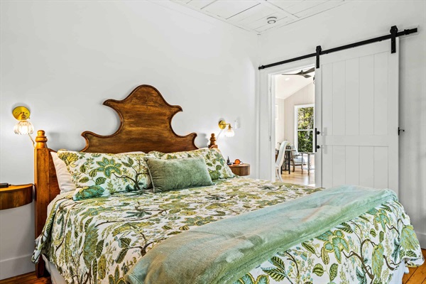 The bedroom retains its rustic cottage charm while providing guest comfort.