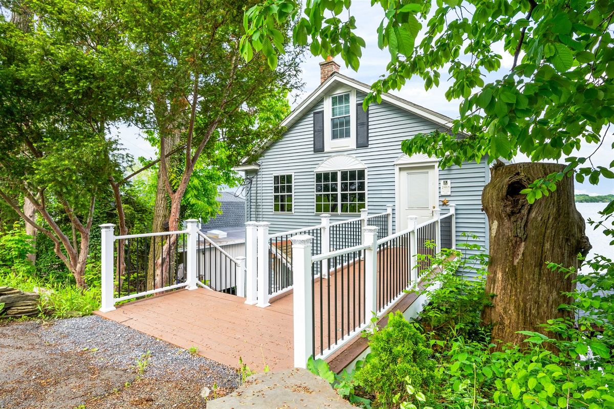 Enjoy direct lakefront living with this charming multi-level getaway, nestled among the trees with panoramic water views! 🌳🏠🌊