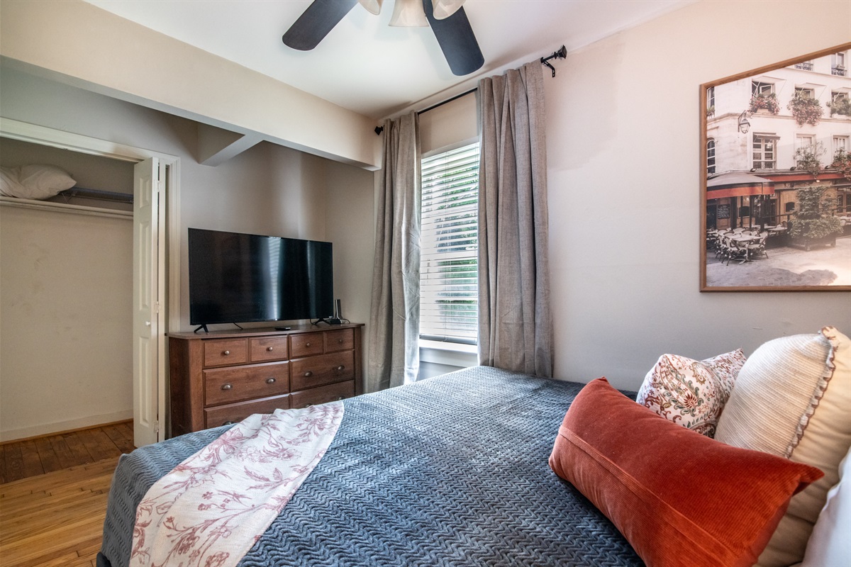Relax in this comfy queen bedroom with TV and spacious layout for a restful stay.
