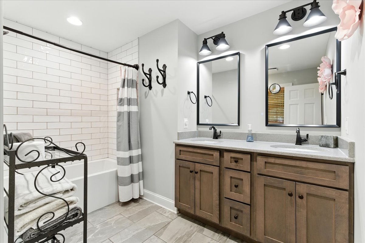 The bathroom features a double sink with spacious countertops and large mirrors