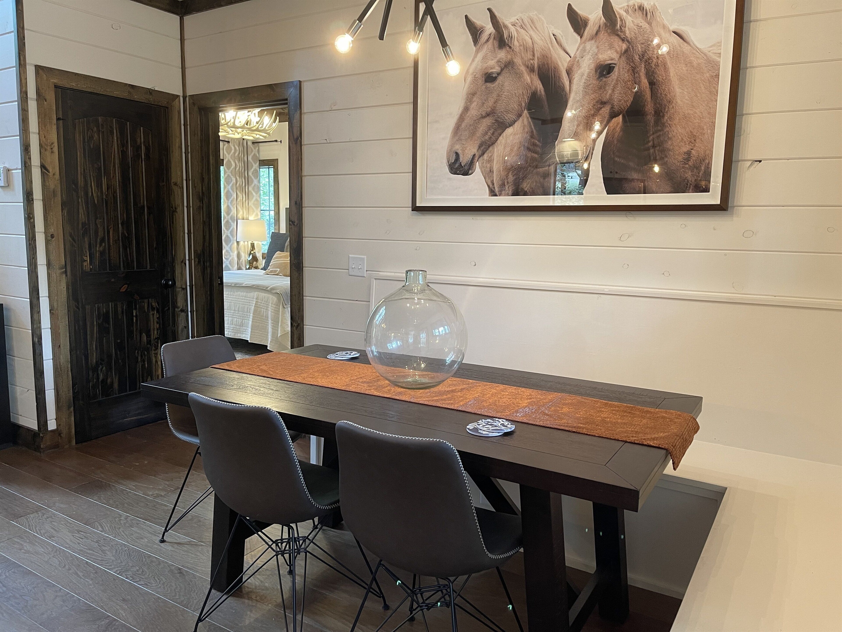 A cozy dining nook. [The master bedroom is visible through the open door].