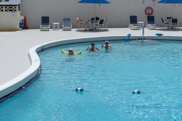 Your backyard. Heated pool, lounge chairs, and blue skies — 30 seconds from your front door.