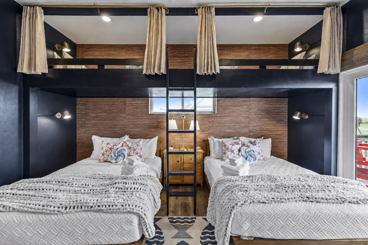 The Fishing Pier sleeps 6. Two Queens on the bottom and above are extra long twins. Pull the curtains for privacy up top!  Each bed has its own reading lamp also. 
