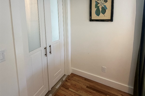 Doors leading out to the dining area with frosted glass for privacy