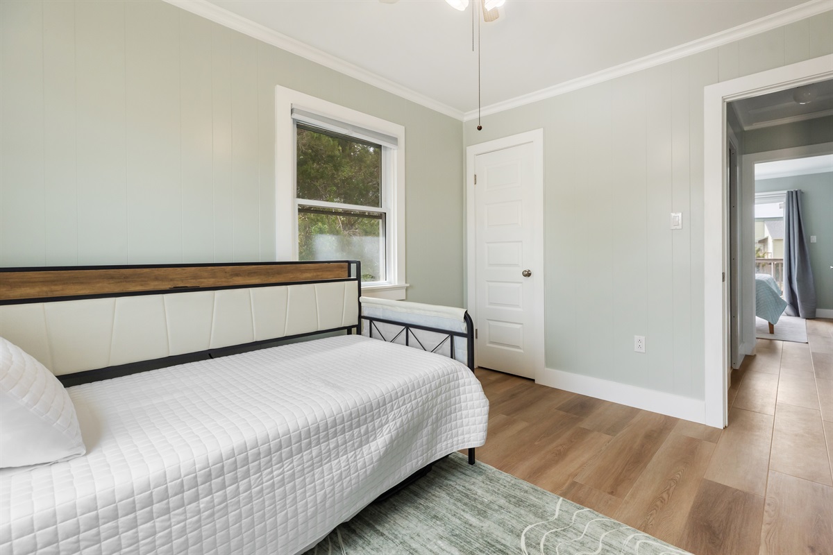 XL Twin bed with a pop up trundle creates a King size bed in this room.