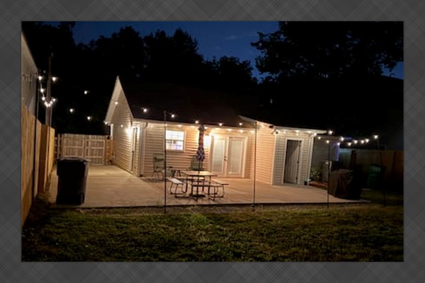 Private outdoor space with new fence, grill, and string lights for ambiance! 
