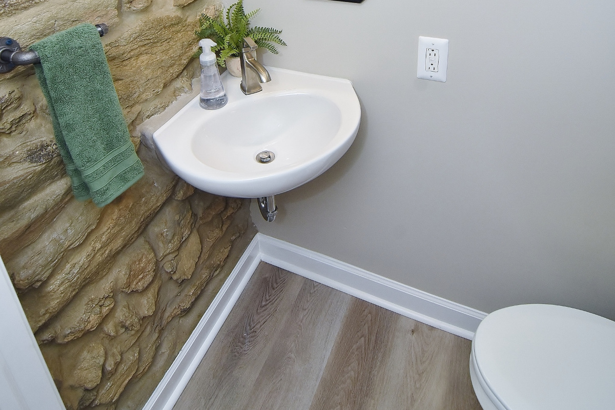 Powder room showing off the natural 100-year-old wall of Wissahickon Schist rock.