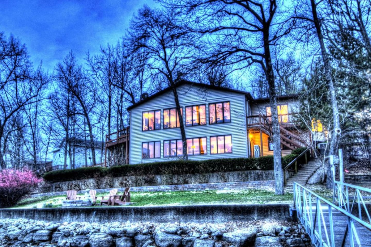 Lake side view of home in the fall at sunset.