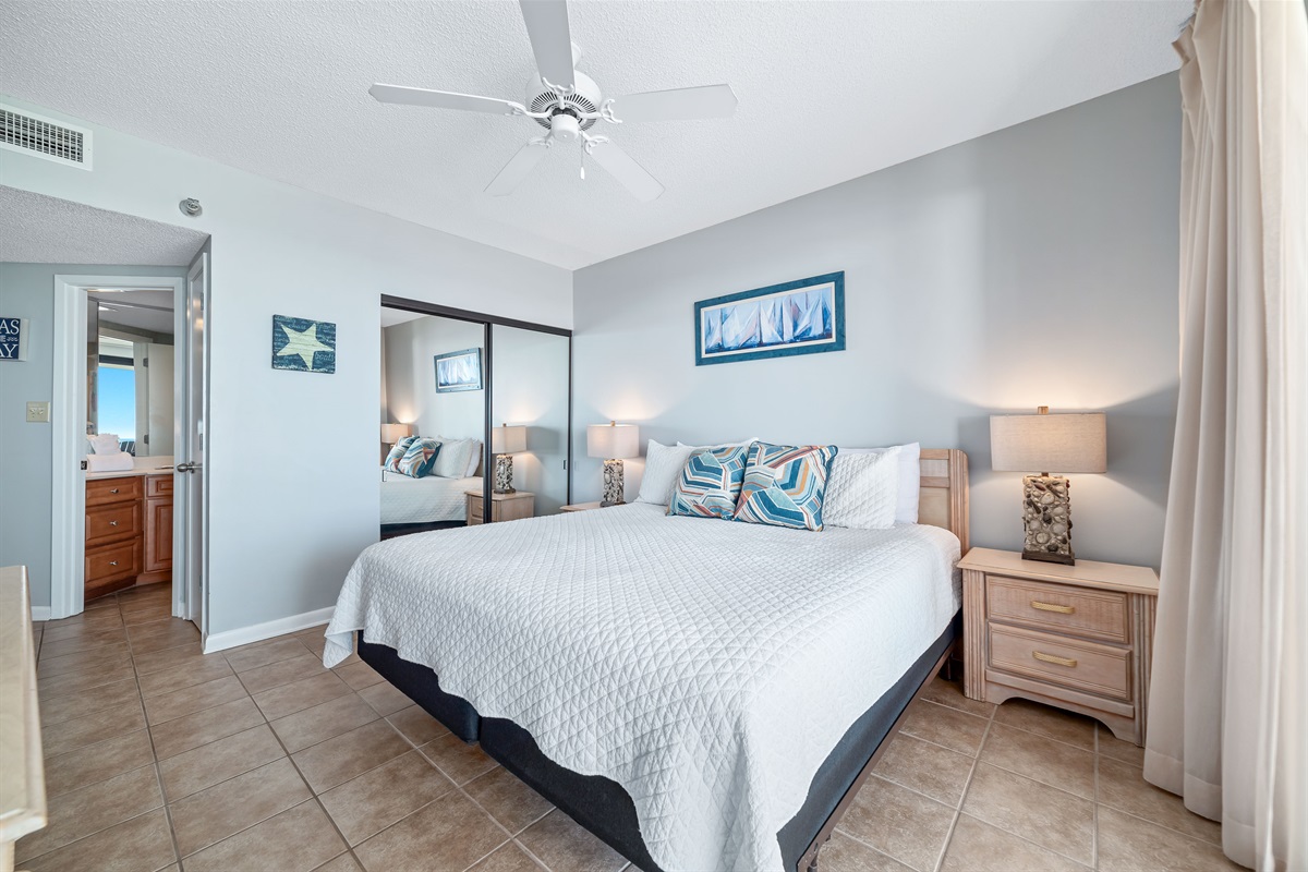Enjoy breathtaking ocean views from this spacious primary bedroom featuring a comfortable king-sized bed, ample storage, and direct access to a private balcony.