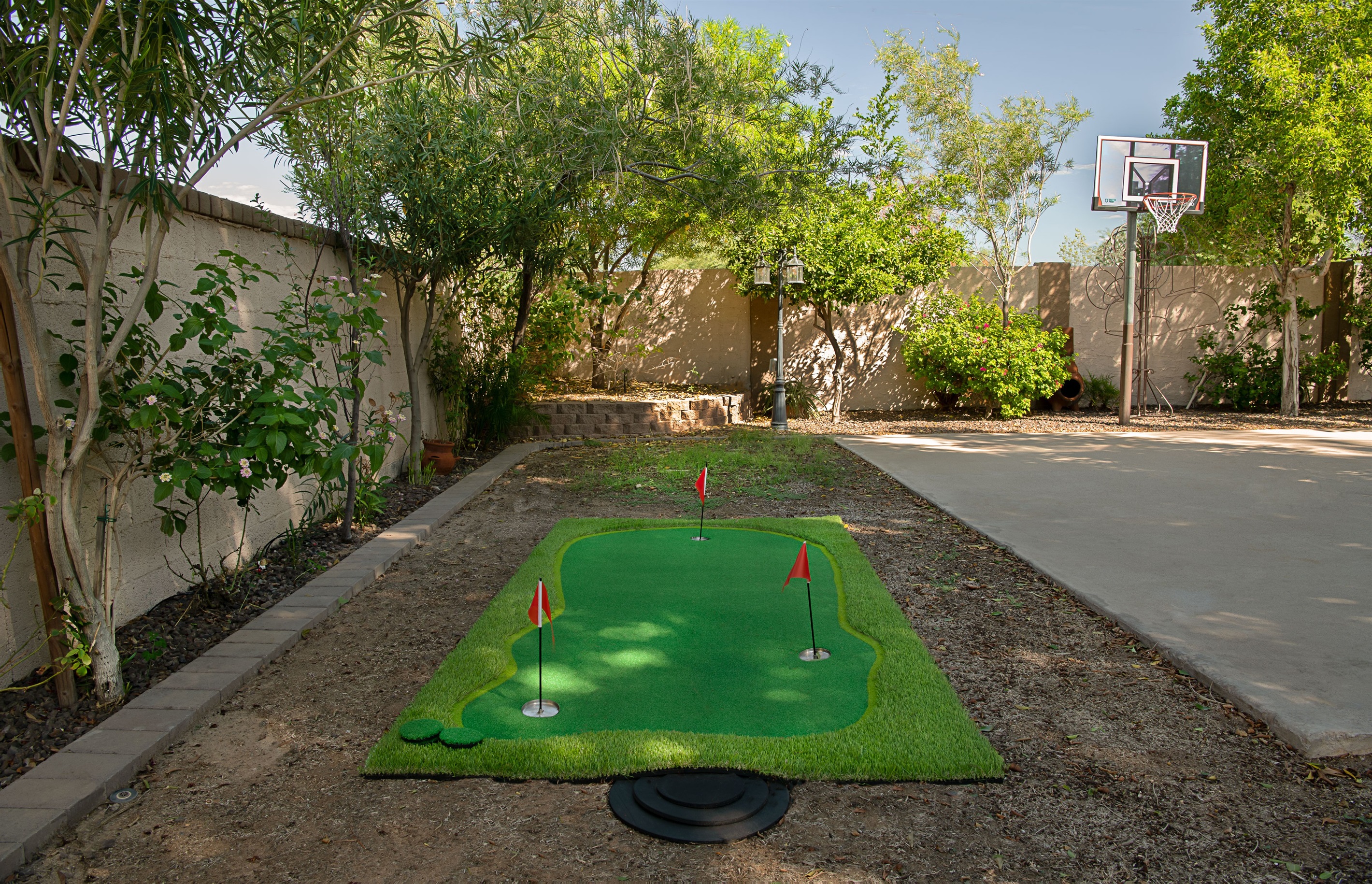 Enjoy endless outdoor fun with your own private putting green and basketball hoop, surrounded by shade trees and sunshine.