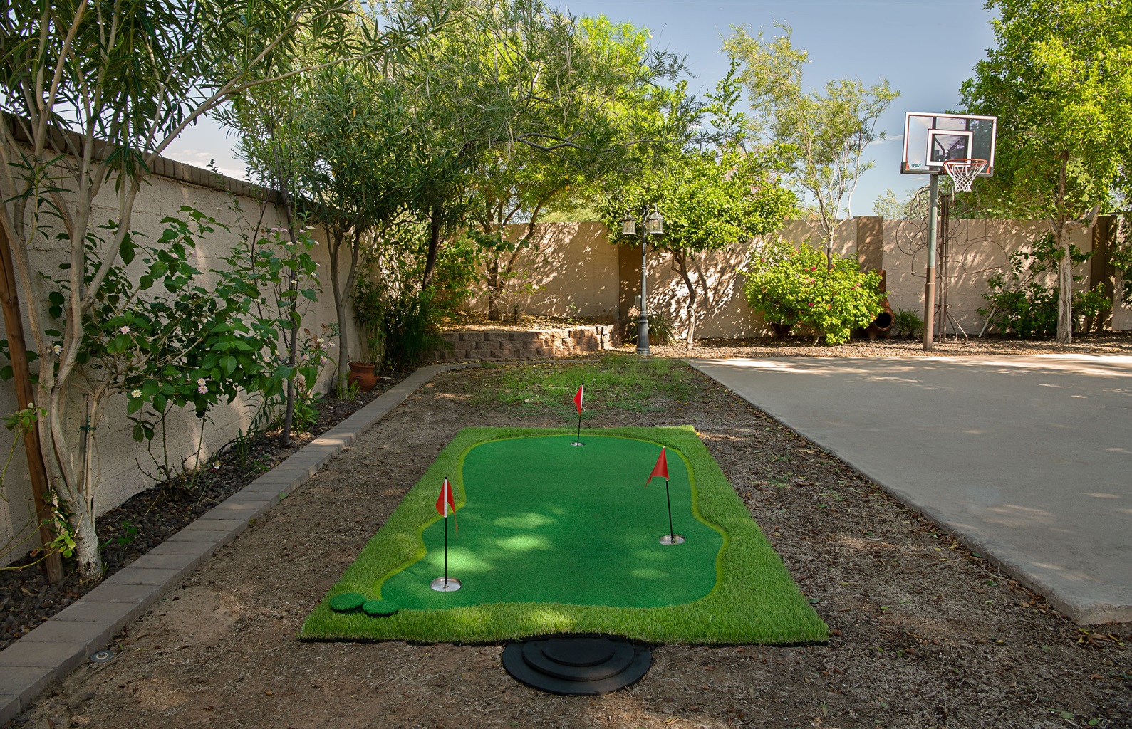 Enjoy endless outdoor fun with your own private putting green and basketball hoop, surrounded by shade trees and sunshine.