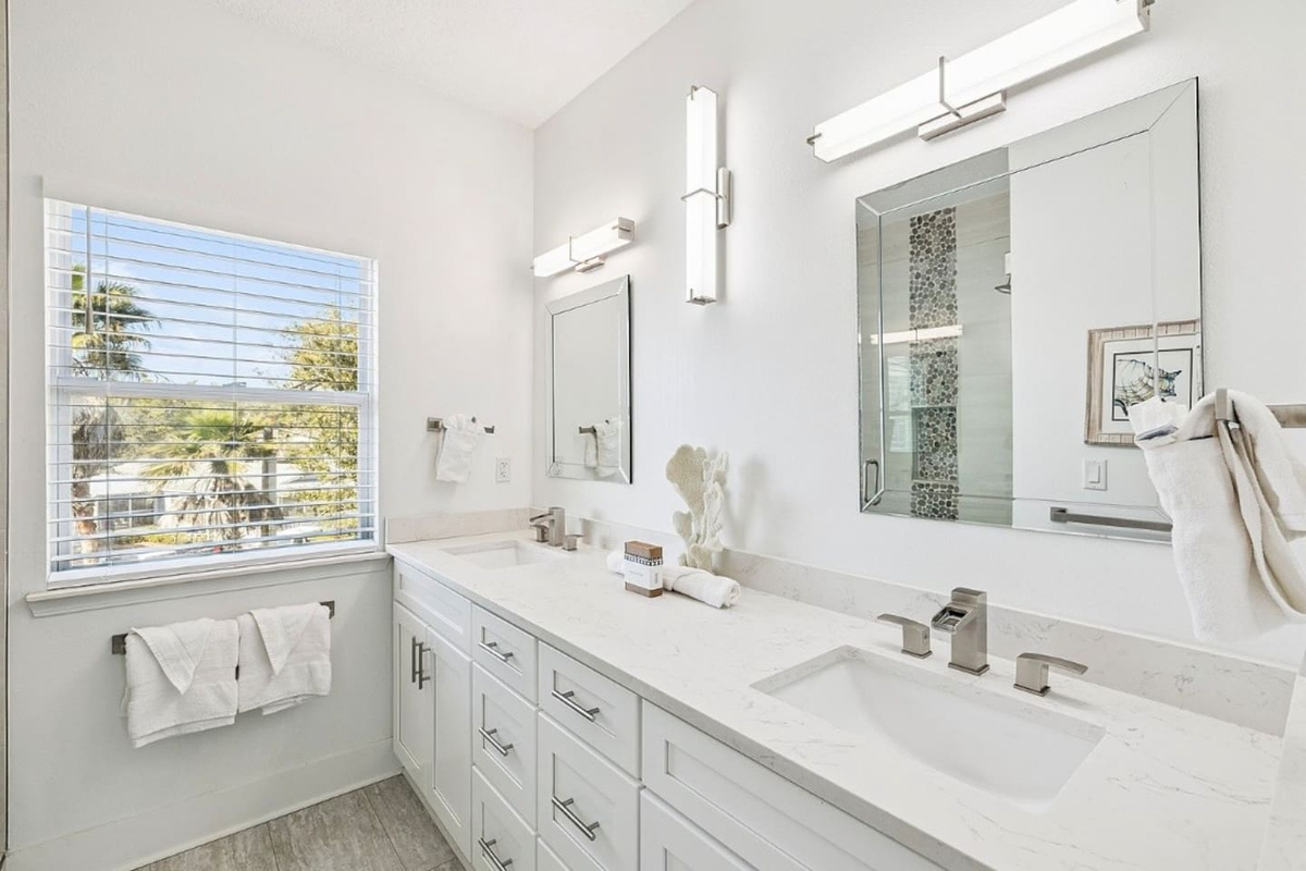 Bright and private en-suite bathroom equipped with contemporary fixtures and an expansive vanity counter