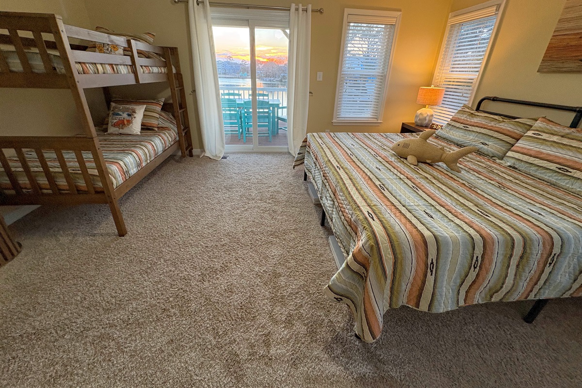 This room features another King sized bed with a set of Twin bunks, an en suite bathroom, & direct balcony access 