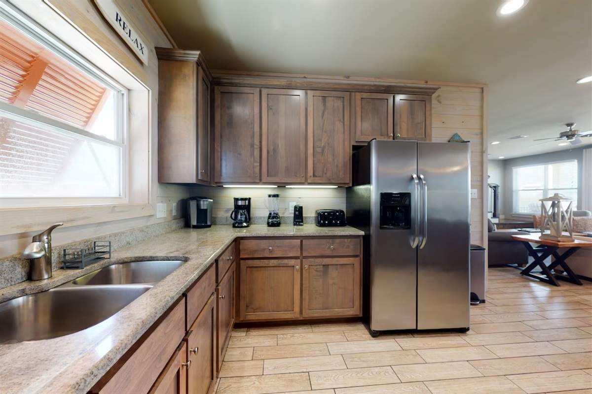 Fully stocked kitchen with stainless steel appliances, granite tops and beautiful view! 