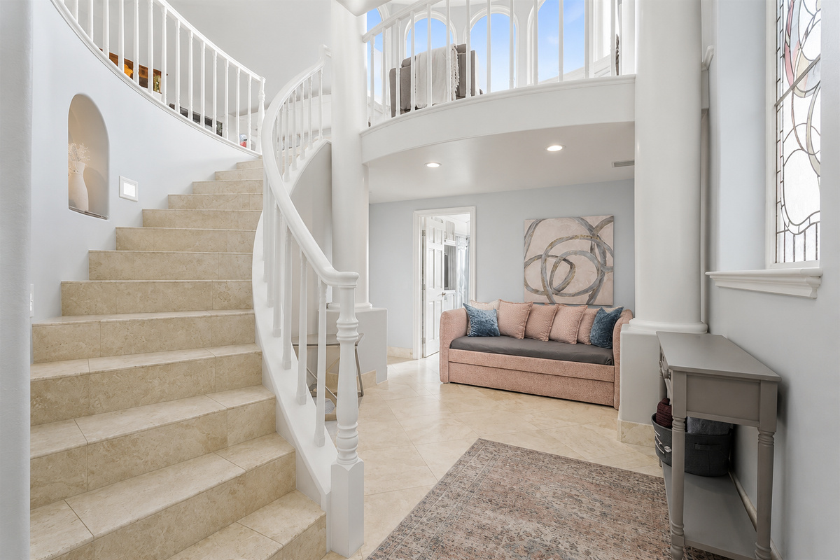 Stairway from Ground Floor to Second Floor Ascend this elegant staircase, where natural light pours in and leads you to the heart of the home – the living and dining spaces.