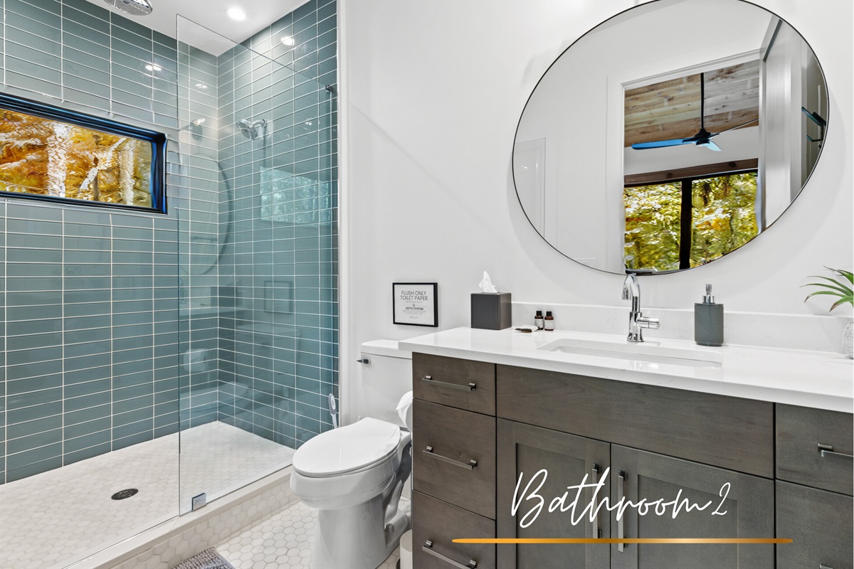 The second bathroom features a walk-in shower, elegant fixtures, and thoughtful modern touches.