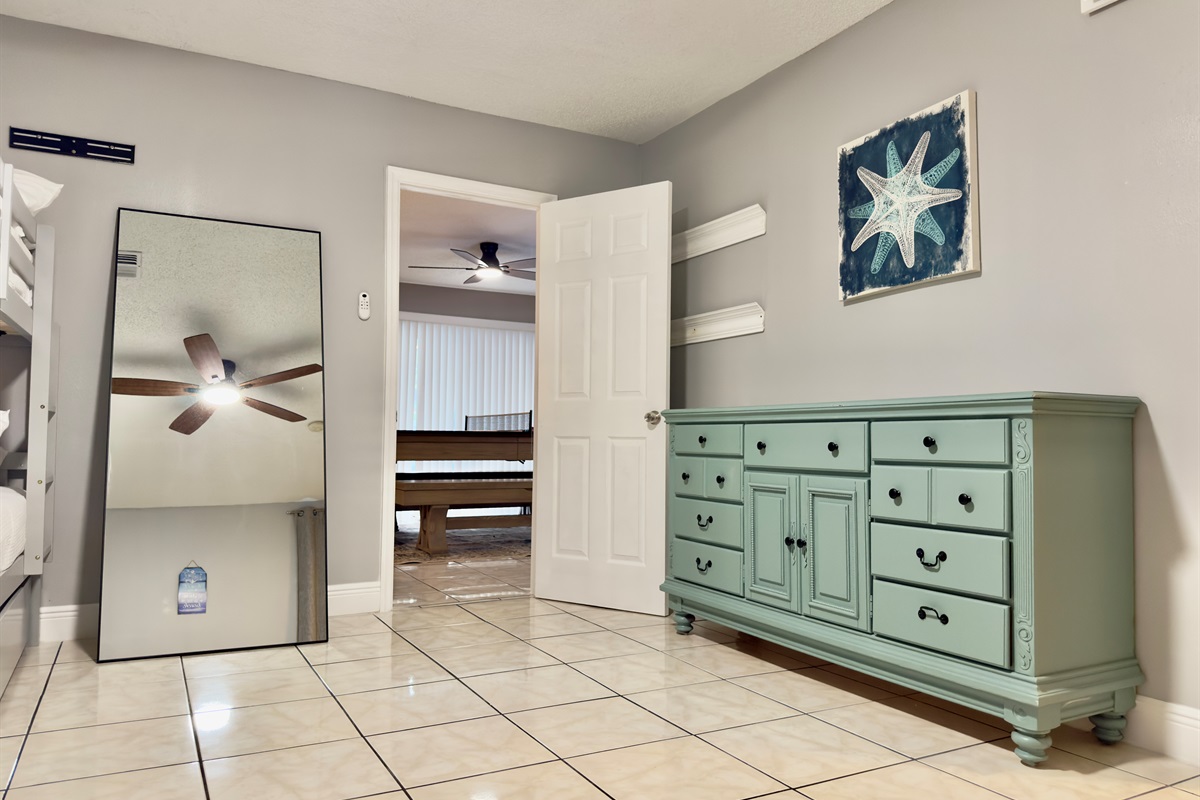 A classic dresser adds storage for clothes and travel essentials, while the floor space offers plenty of room to unpack and stretch out.